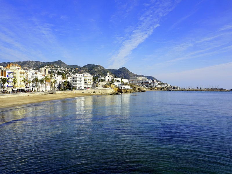 Aproveite para visitar as praias Sitges durante o roteiro de trem na Espanha