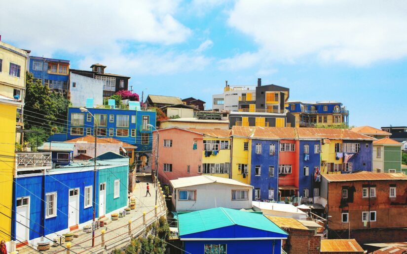 onde ficar em Valparaíso no bairro Cerro Alegre Casas coloridas nas encostas sob um céu azul no Chile - explore entre as vibrantes casas locais próximas a Viña del Mar